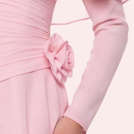 The hand-formed chiffon rose at the waist